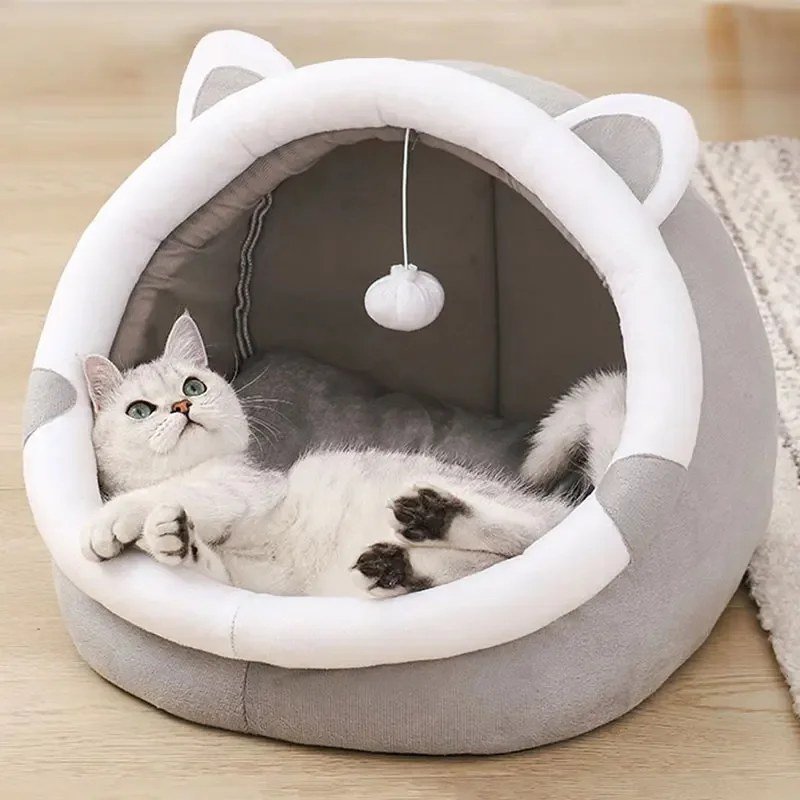 White cat lying in the Grey & White cat-ear cave bed